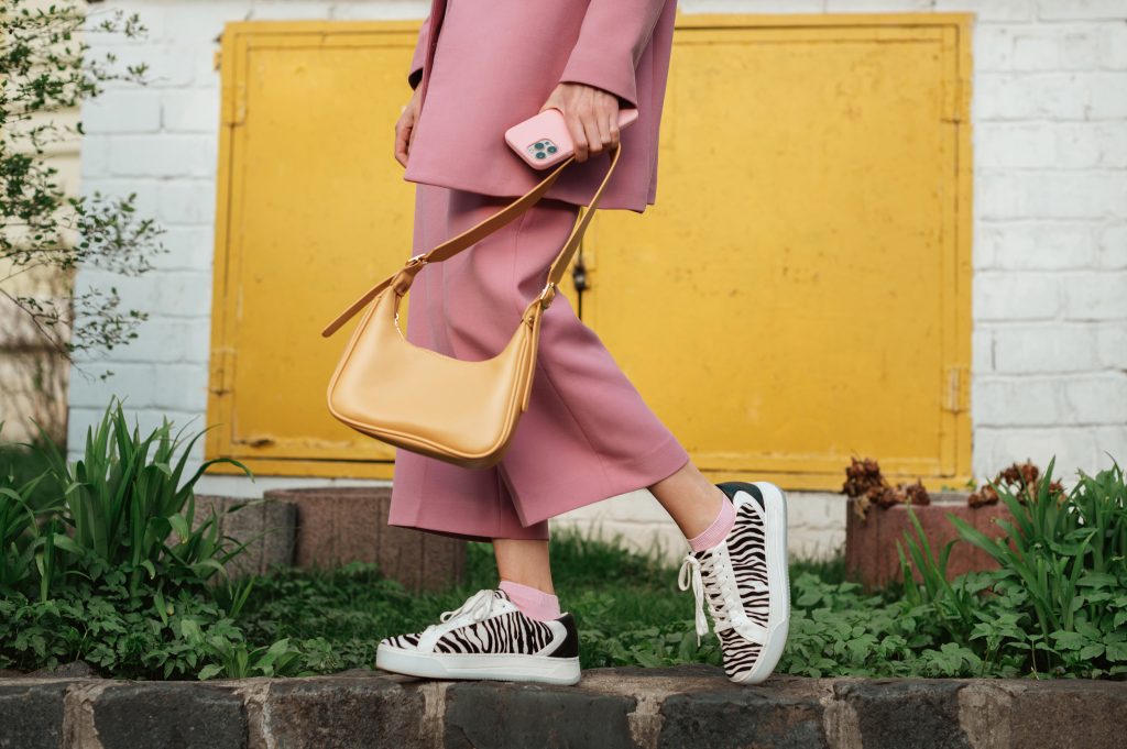 Street fashion elements: woman wearing trendy outfit with pink s